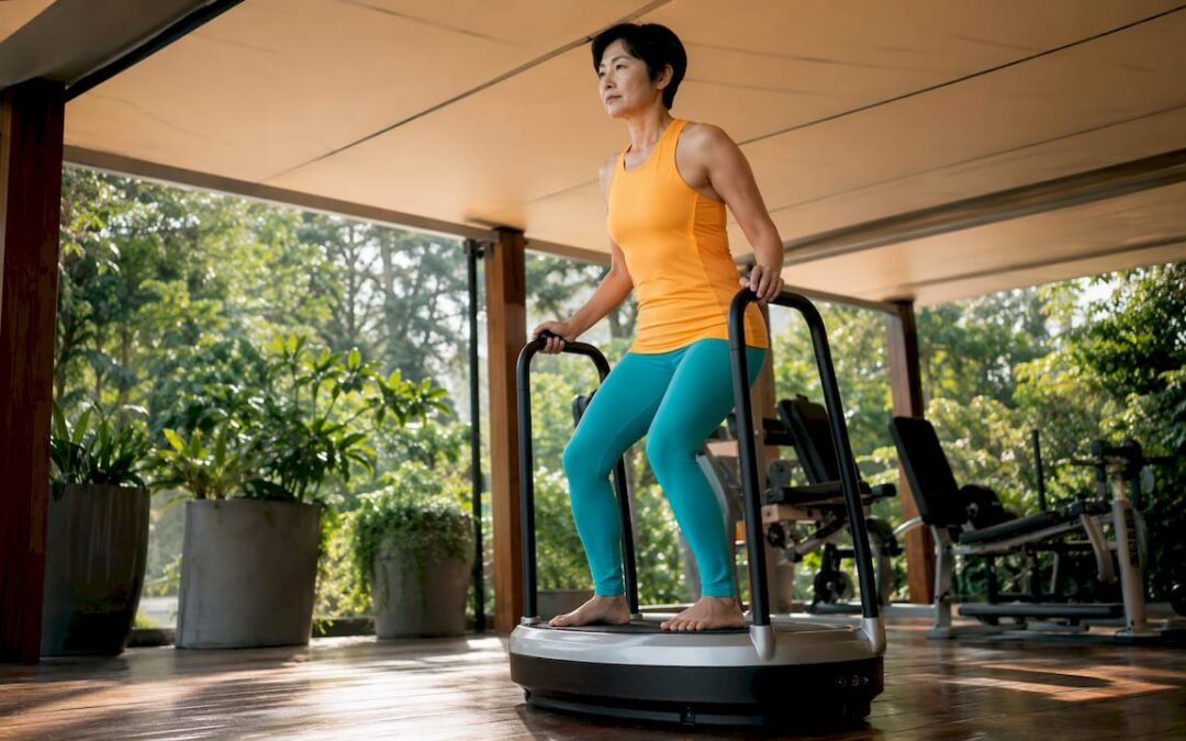 Woman using whole body vibration plate in clinic