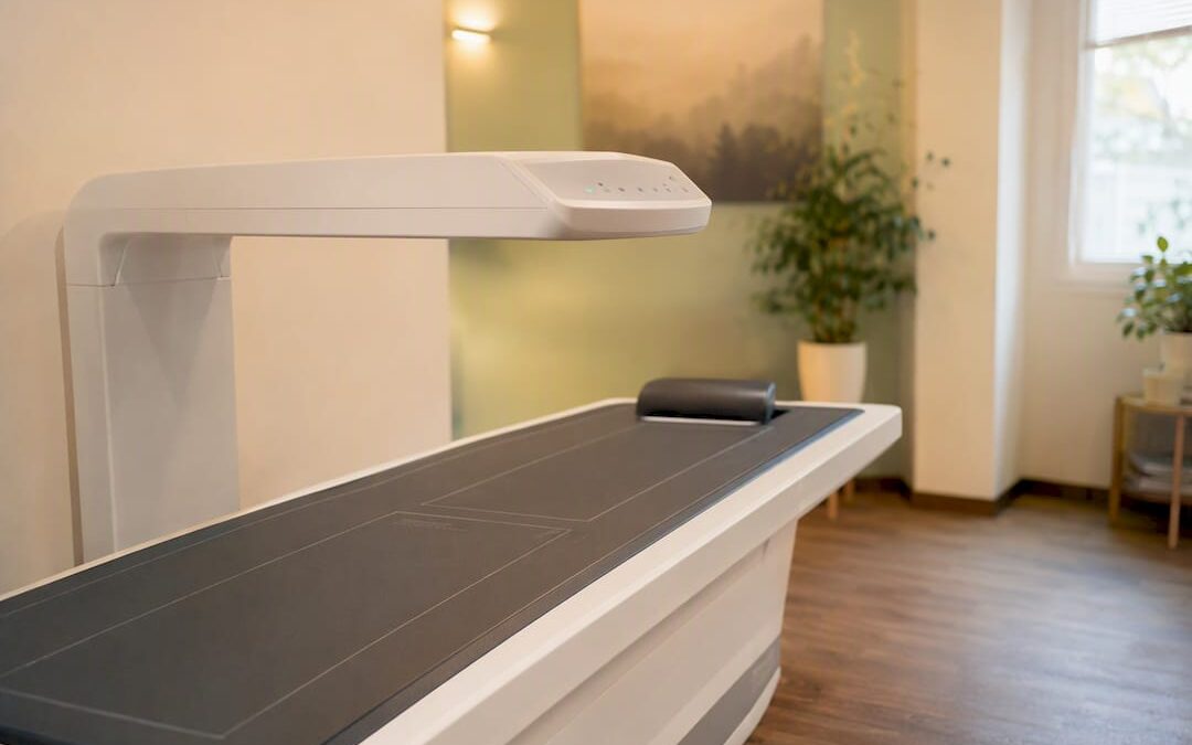 Empty DEXA scanner table in clinical room